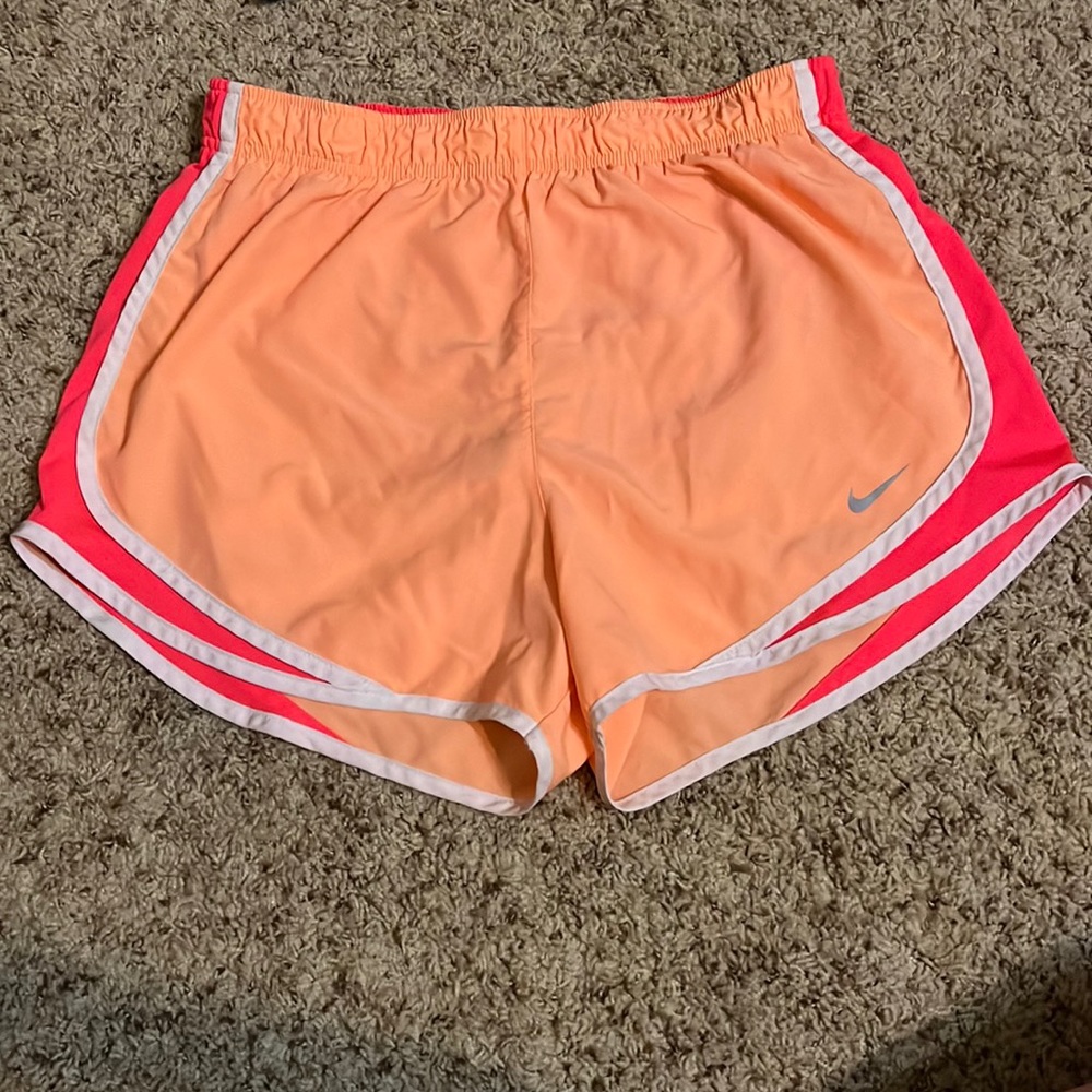 Like new, Nike running shorts size medium. Neon orange with hot pink outline.